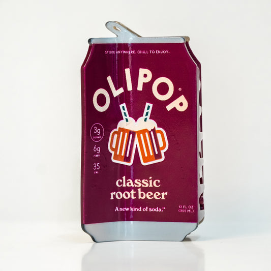 The OLIPOP Classic Root Beer can hair claw on a white background: a maroon can with two clinking root beer mugs and the text 'classic root beer'
