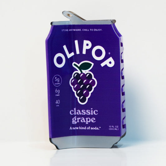 The OLIPOP Classic Grape can hair claw on a white background: a purple can with a bunch of grapes and the text 'classic grape'