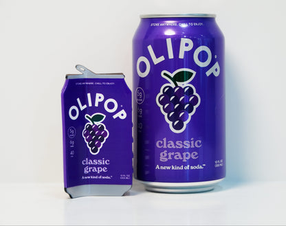 A Classic Grape Olipop hair claw next to a can of olipop classic grape