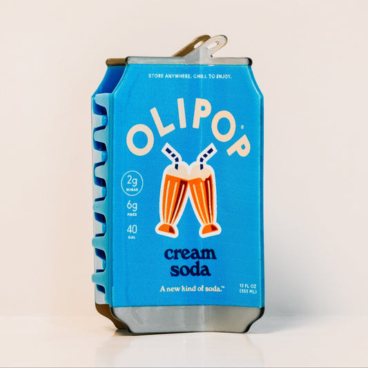 The OLIPOP Cream Soda can hair claw on a white background: a light blue can with two cream soda floats and the text 'cream soda'