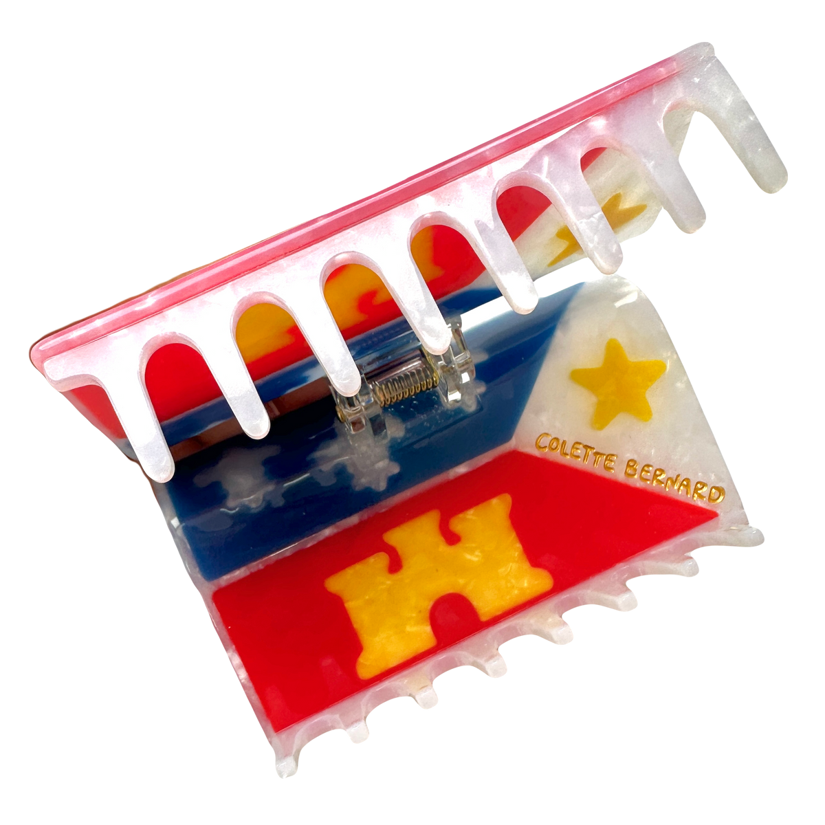 The acadiana flag hair claw opened, showing the inside of the claw