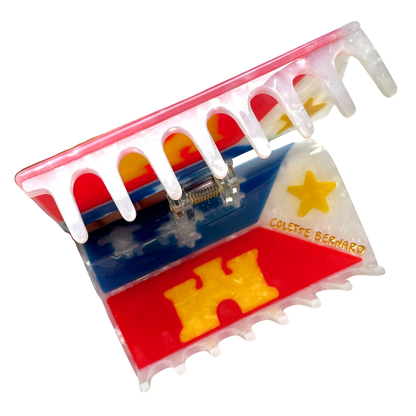 The acadiana flag hair claw opened, showing the inside of the claw