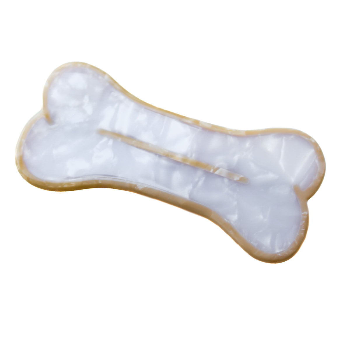 A hair clip shaped like a bone. The bone is white with a beige outline and line in the center