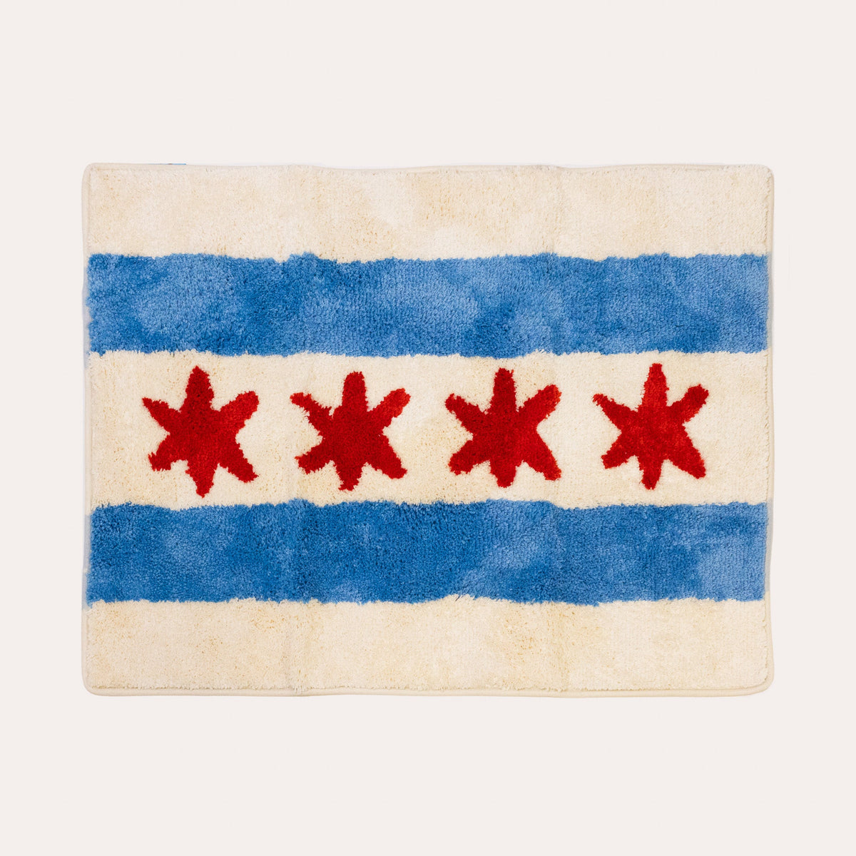 A rectangular plush rug featuring the Chicago city flag design, with two blue horizontal stripes and four red six-pointed stars on an off-white background, shown against a light cream backdrop.