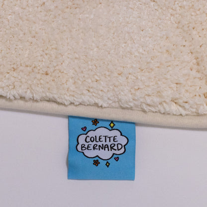 the tag of the rug, which features the white Cloud colette bernard logo