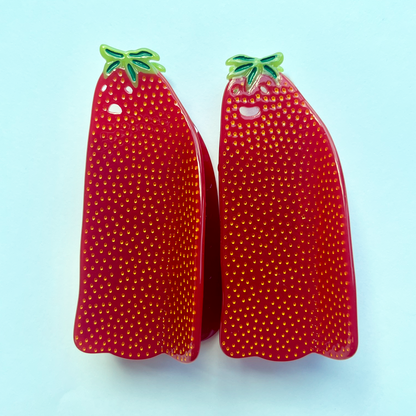 two berry ghost hair claws side by side. One is frowning, one is smiling.