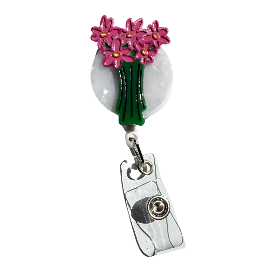 Retractable badge holder with pink flowers on a white background