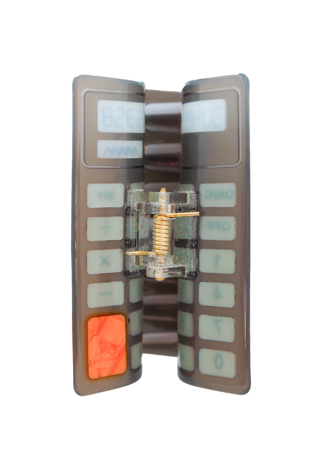 The back of the calculator hair claw, showing the spring mechanism