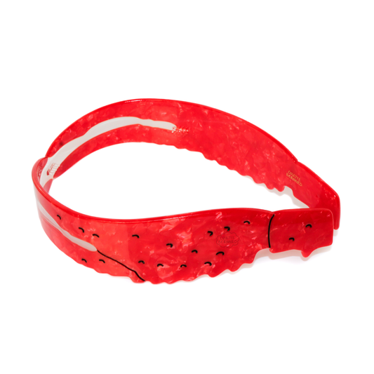 The Crawfish Headband, a red marbled headband shaped like a crawfish with black dots, on a white background.
