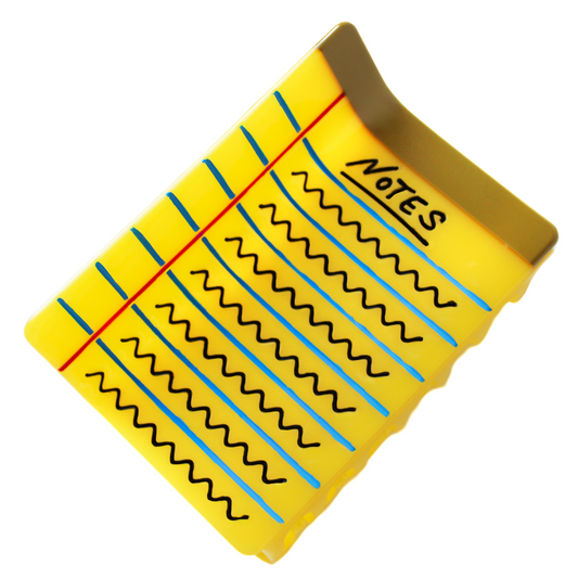 The Legal Notepad Hair Claw, shaped like a yellow legal pad with blue ruled lines, a red margin line, a brown binding strip and black handwriting that reads 'NOTES' with squiggly lines, on a white background.